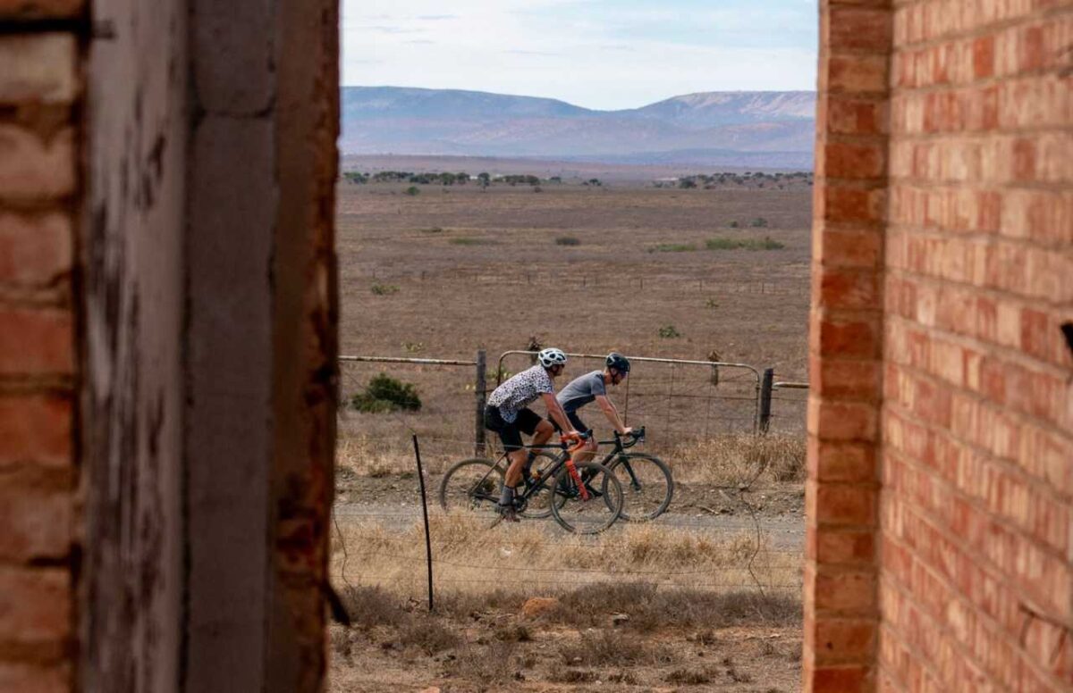 chasing-the-sun-gravel-bike-bike-market-1280x828 two gravel riders on a dirt road